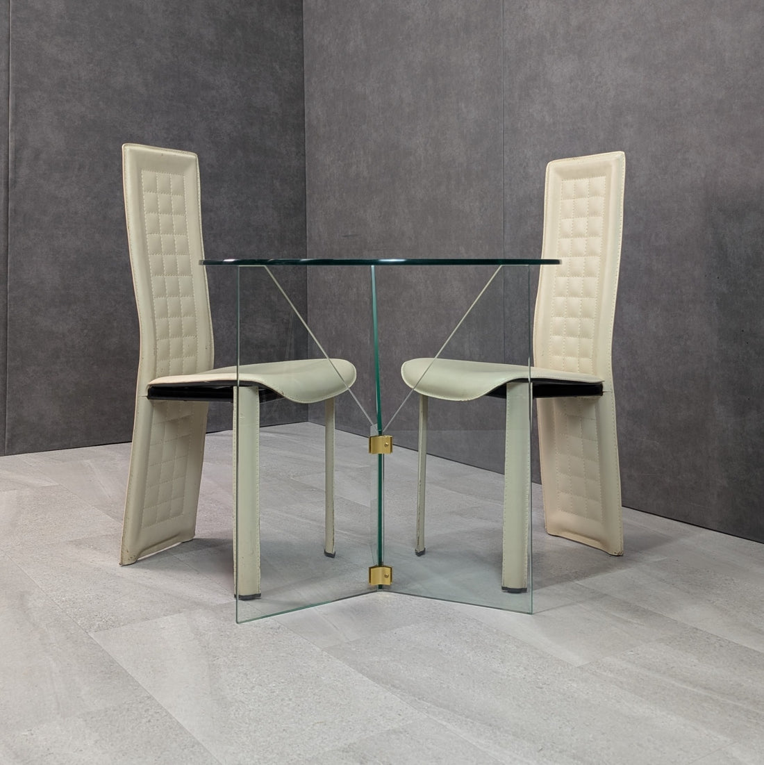 Harper Fredericks small round glass table photographed with two cream dining chairs for scale, chairs not included