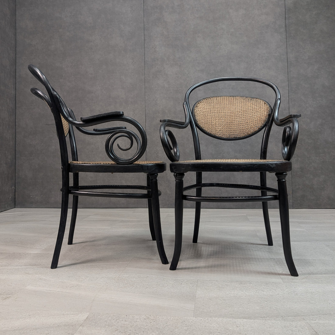Side profile and front view of Thonet No 11 style bentwood armchairs with curled scroll armrests