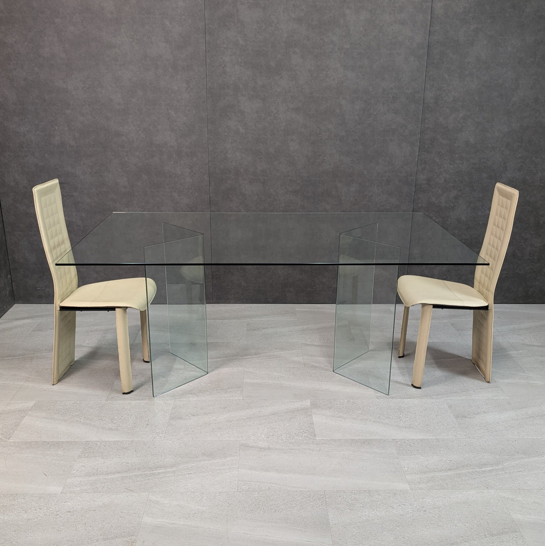 Architectural clear glass dining table with rectangular glass top and two folded glass supports, front view