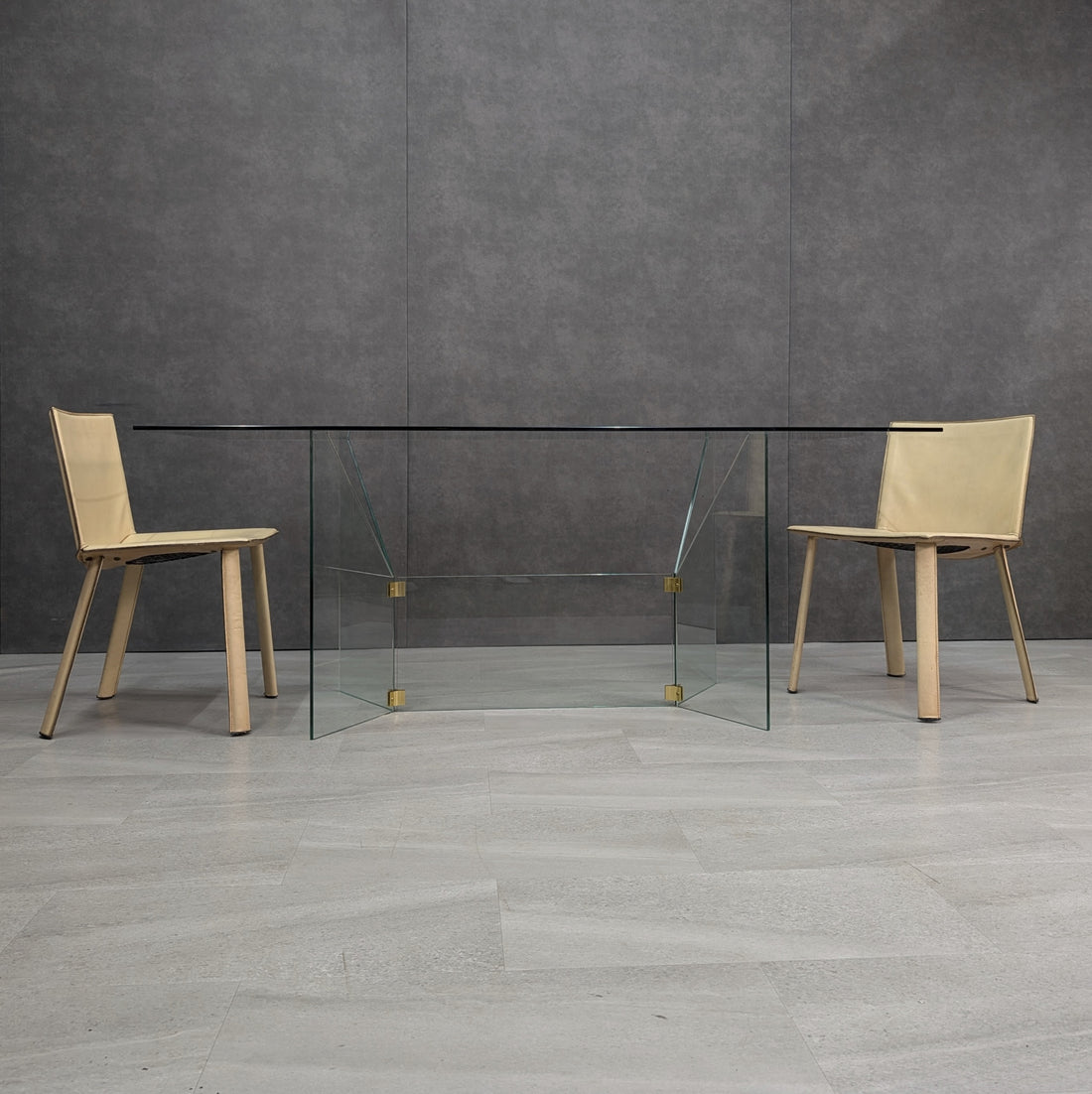 GRZ 2C clear glass dining table shown with two chairs, front view