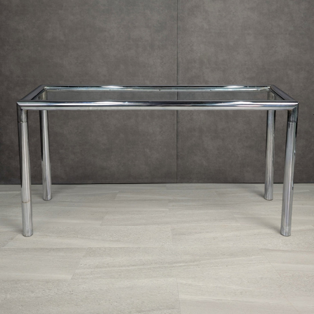 Circa 1970s chrome tubular steel console with clear inset glass top, front view