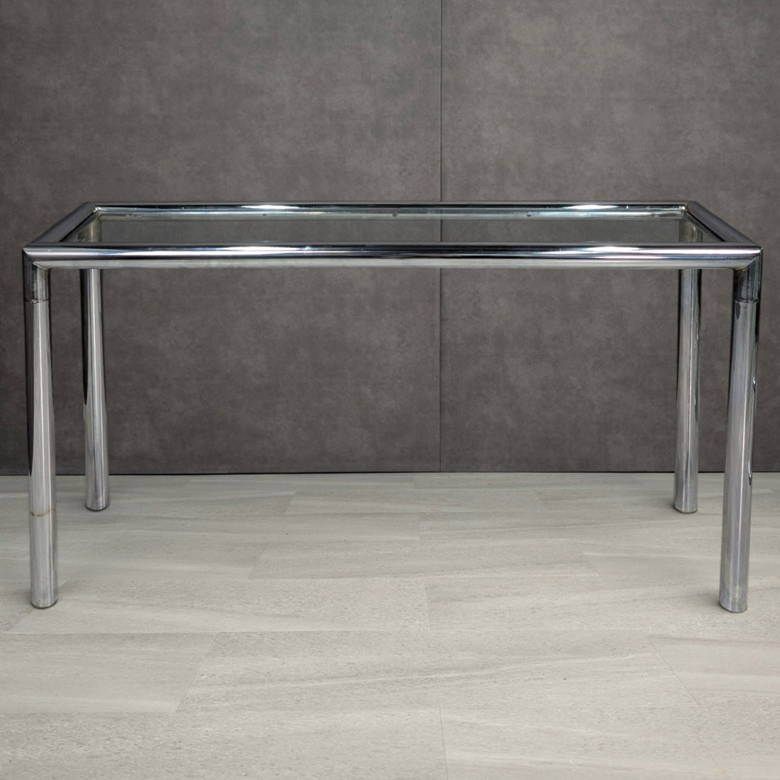 Chrome and clear glass console table from an elevated front angle