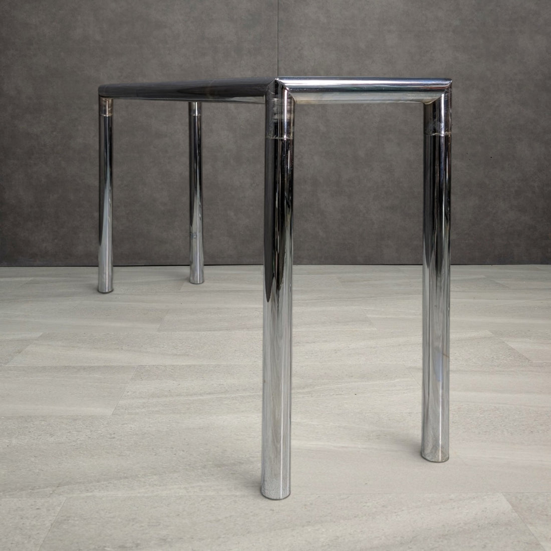 End view of console table showing substantial round chrome steel tubing and corner joints