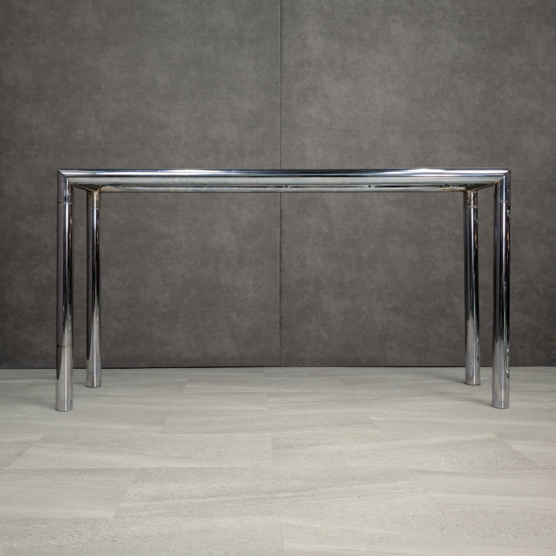 Alternate view of vintage chrome console showing the glass support frame and surface patina