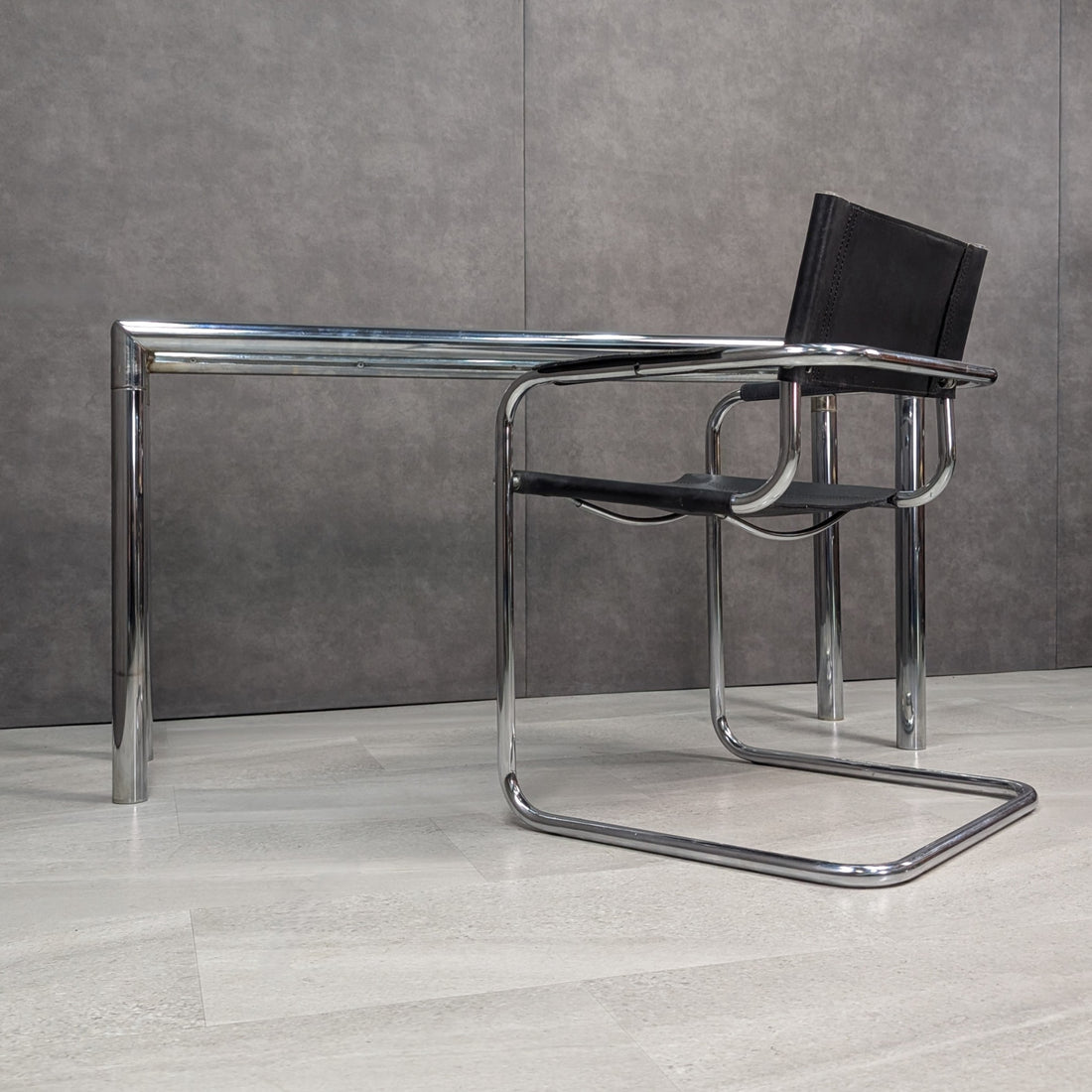 Circa 1970s chrome glass console with matching Bauhaus style leather and chrome armchair