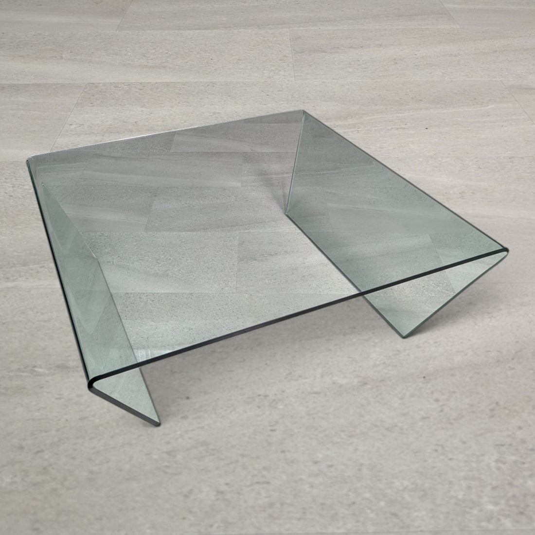 Overhead three-quarter view of the 100cm square clear glass waterfall coffee table