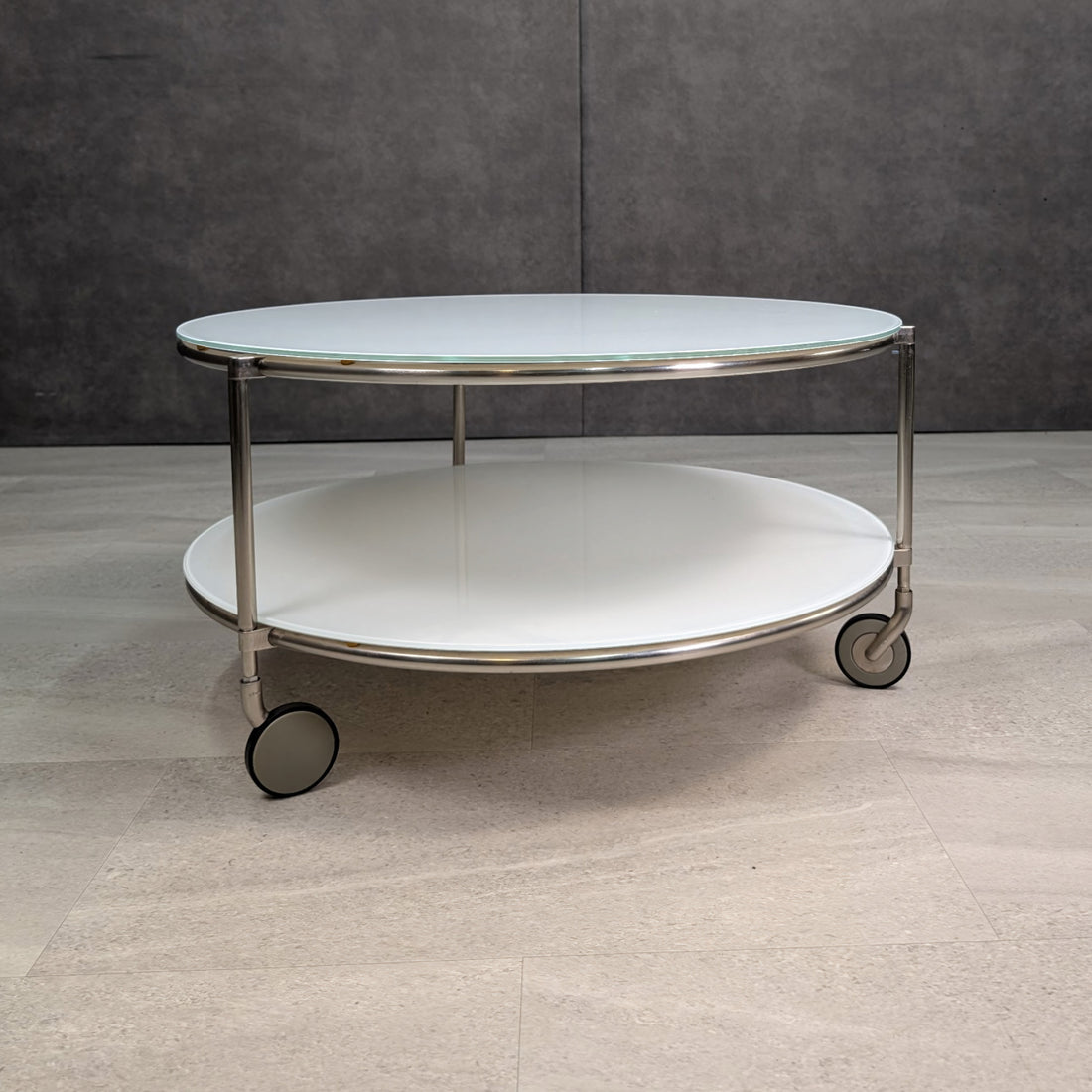IKEA Strind coffee table side profile showing two glass shelves and wheels