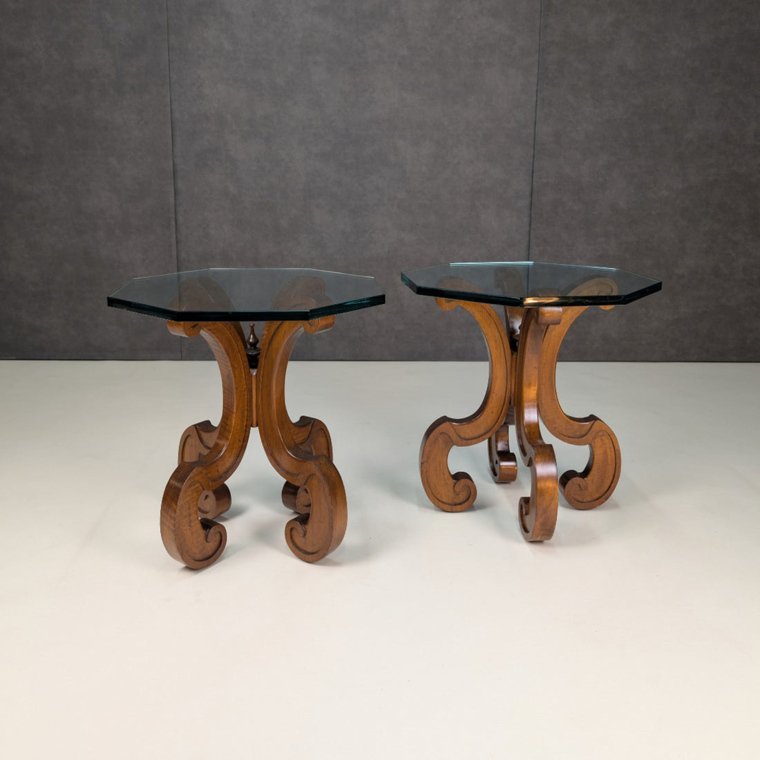 Pair of vintage timber scroll base side tables with thick octagonal clear glass tops