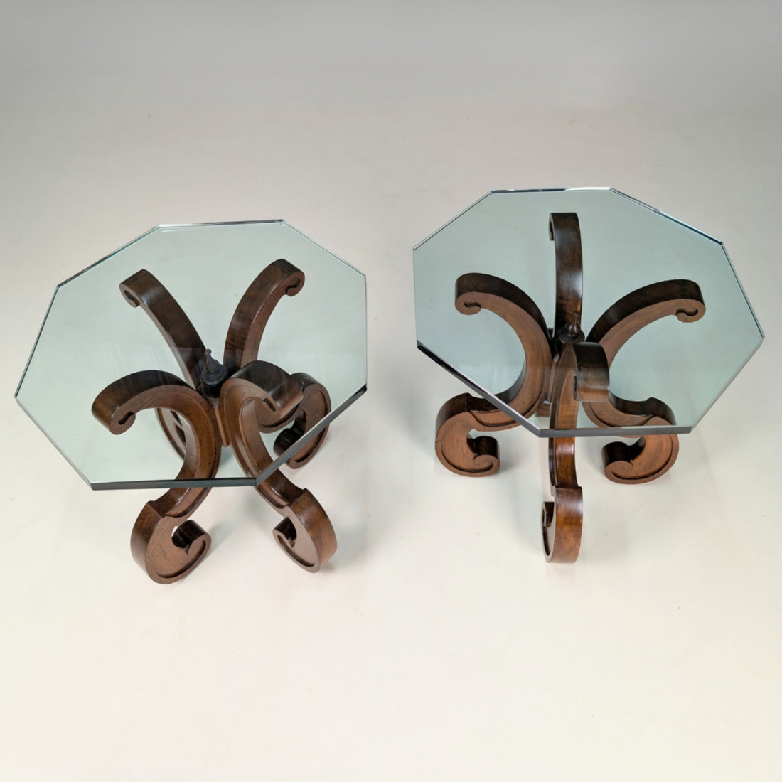 Overhead view of both octagonal glass tops and the timber scroll supports beneath