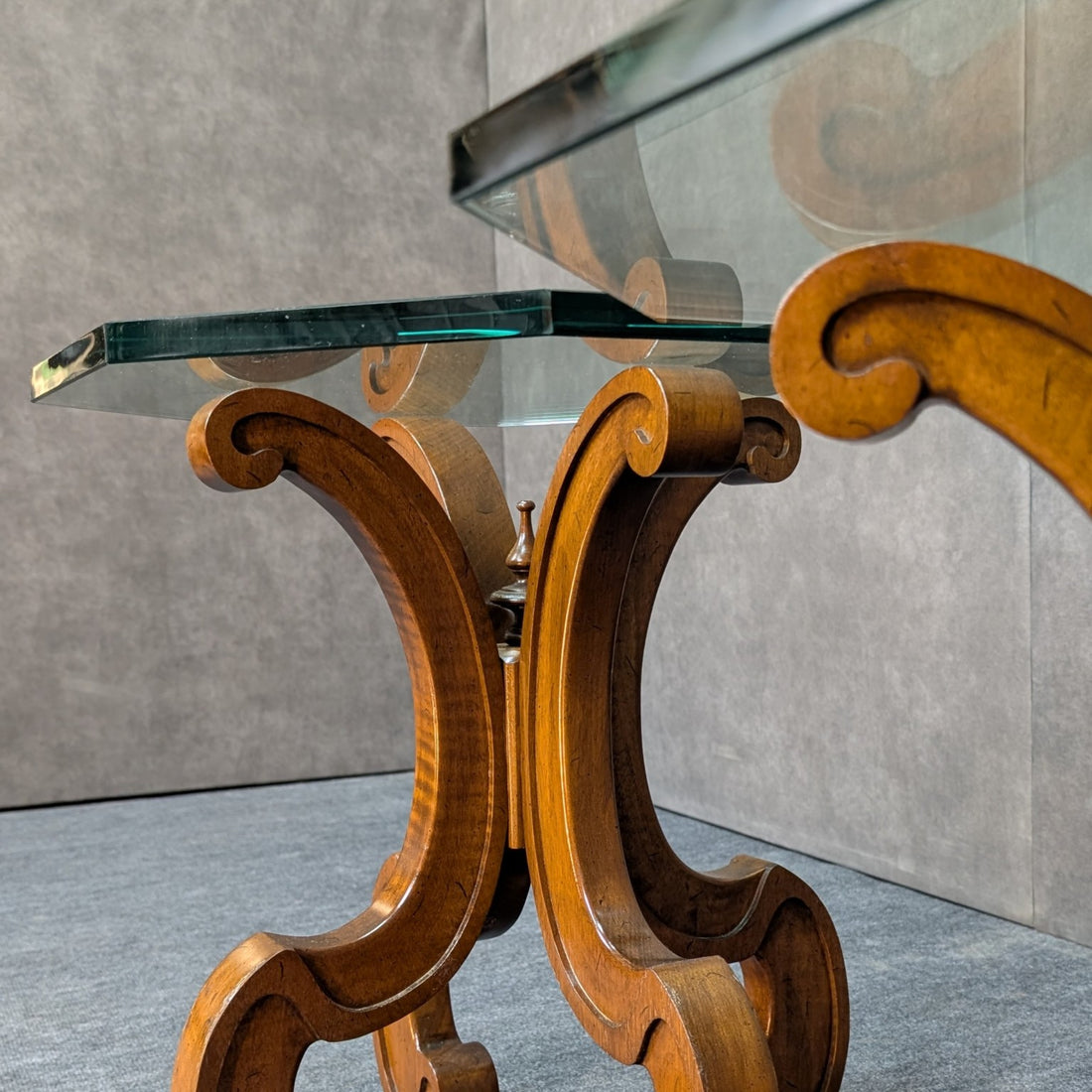 Detail of the timber scroll supports, central finial and thick glass top