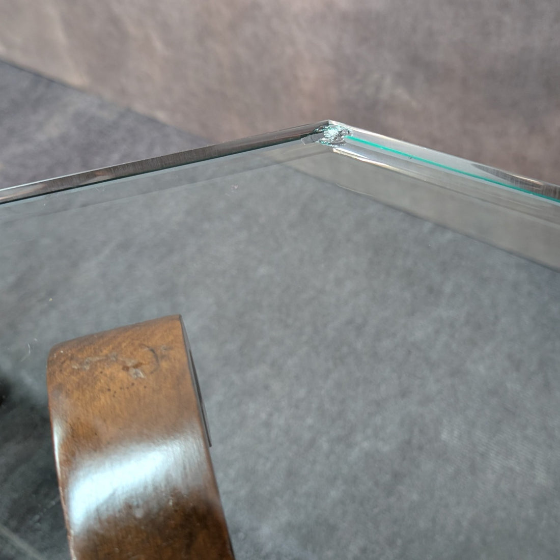 Condition detail showing a chip at one corner of one glass tabletop