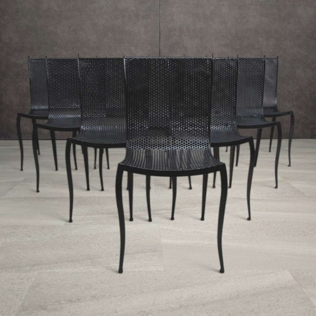 Vintage black perforated aluminium dining chairs with curved seats and slender tapering legs