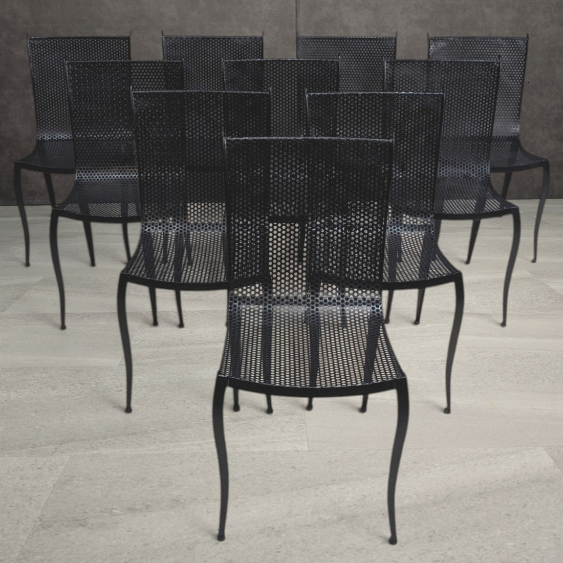 Vintage black perforated aluminium dining chairs with curved seats and slender tapering legs