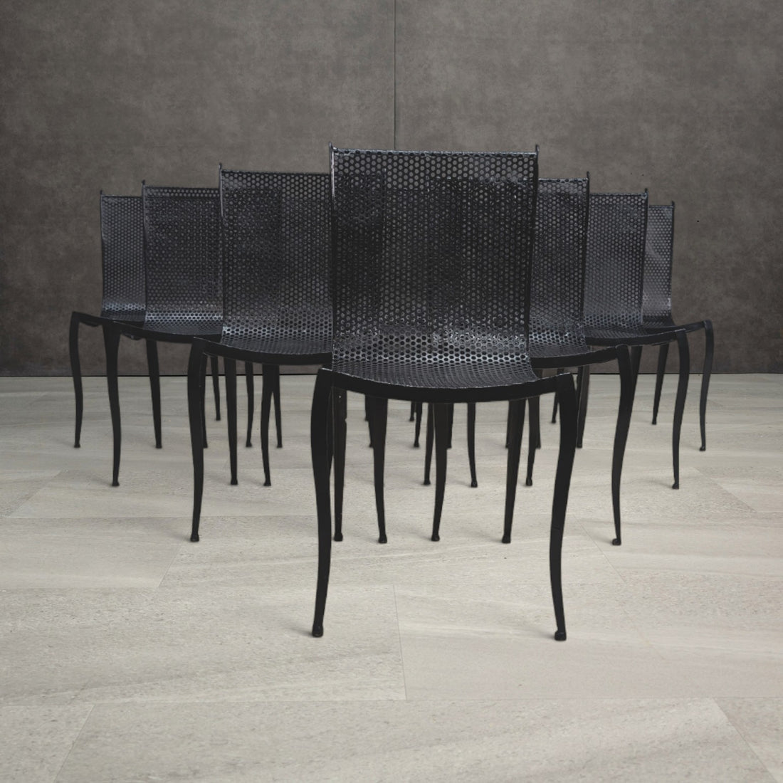 Vintage black perforated aluminium dining chairs with curved seats and slender tapering legs