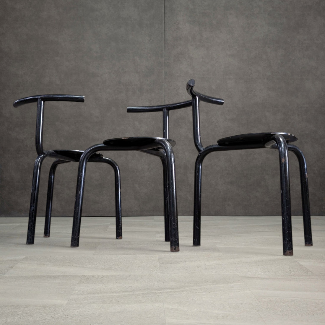 Low angle view of heavy tubular steel chairs showing three leg construction