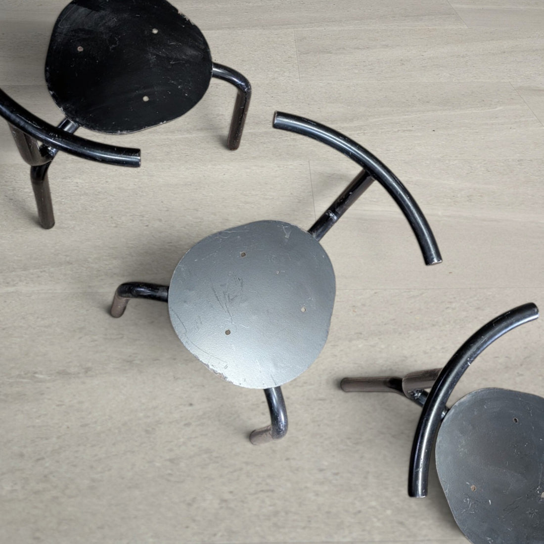Overhead detail of circular steel seat plates with mounting holes for replacement seat pads