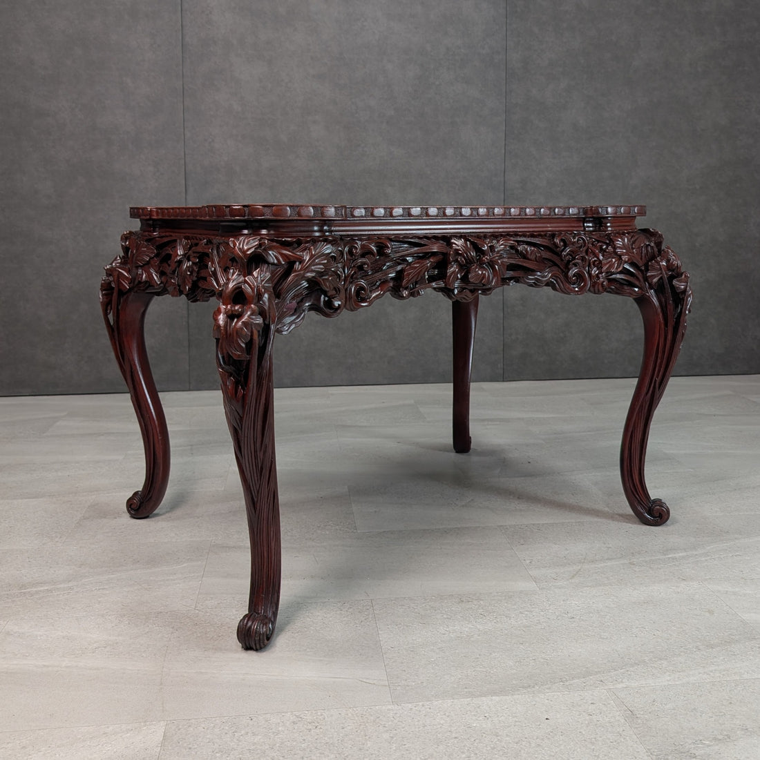 Japanese Meiji period carved Hongmu library writing table circa 1900 showing rich floral apron and cabriole scroll feet