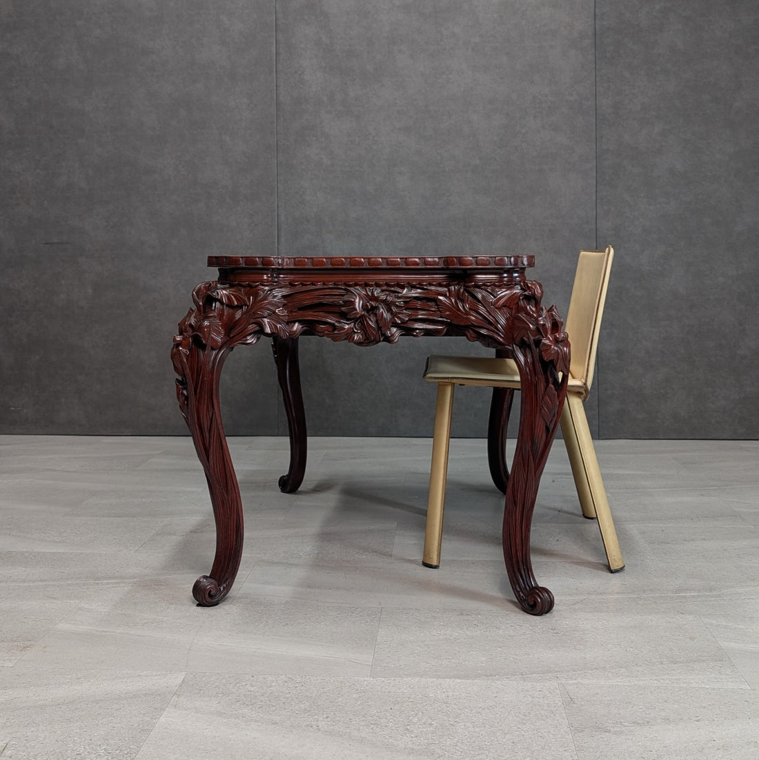Side view of Meiji export carved writing table with contrasting chair for scale; chair not included