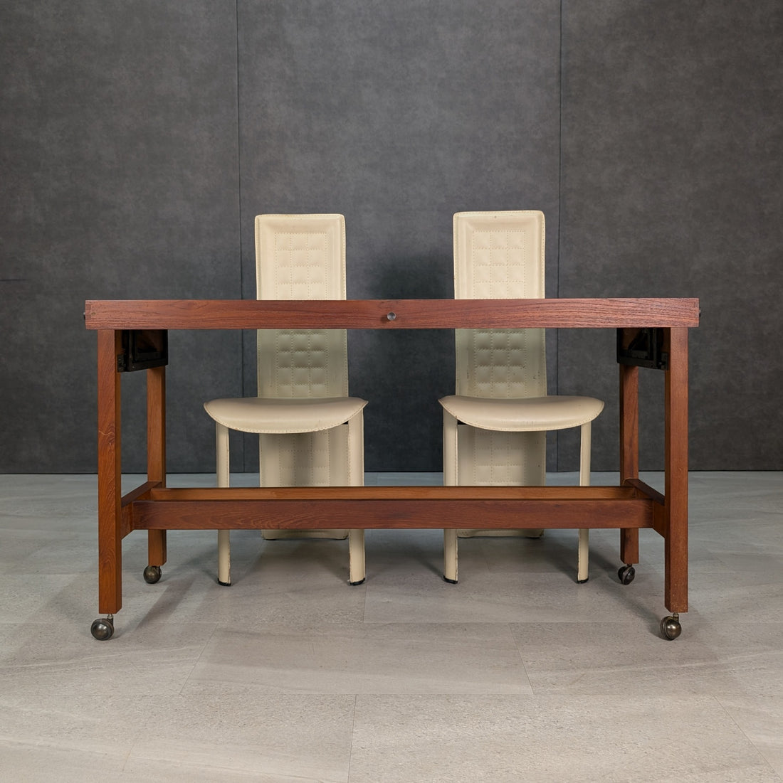 Vintage mid century teak console table viewed from front with cream dining chairs for scale