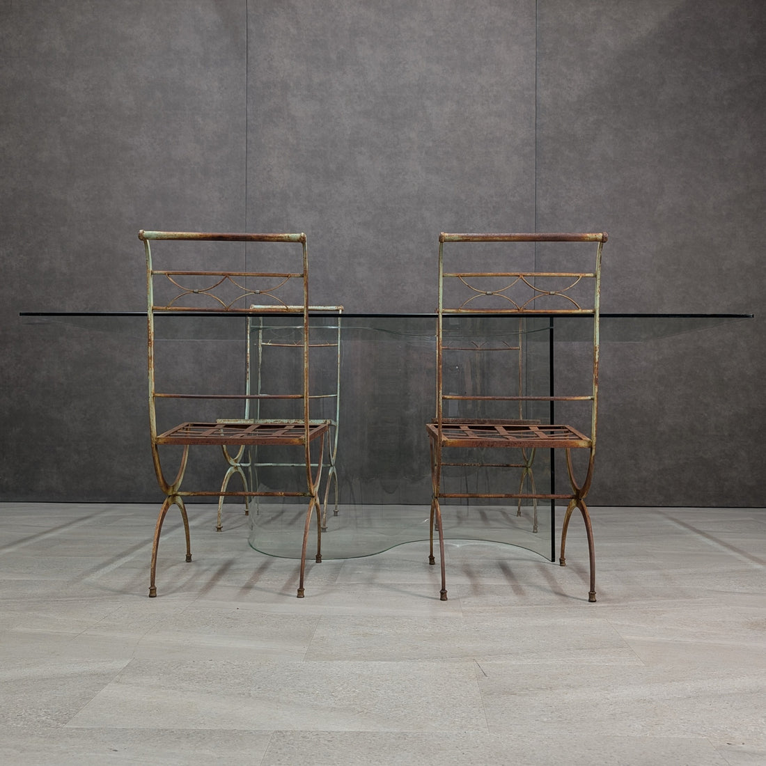 Wrought iron and clear glass dining setting, low front view showing chair frames