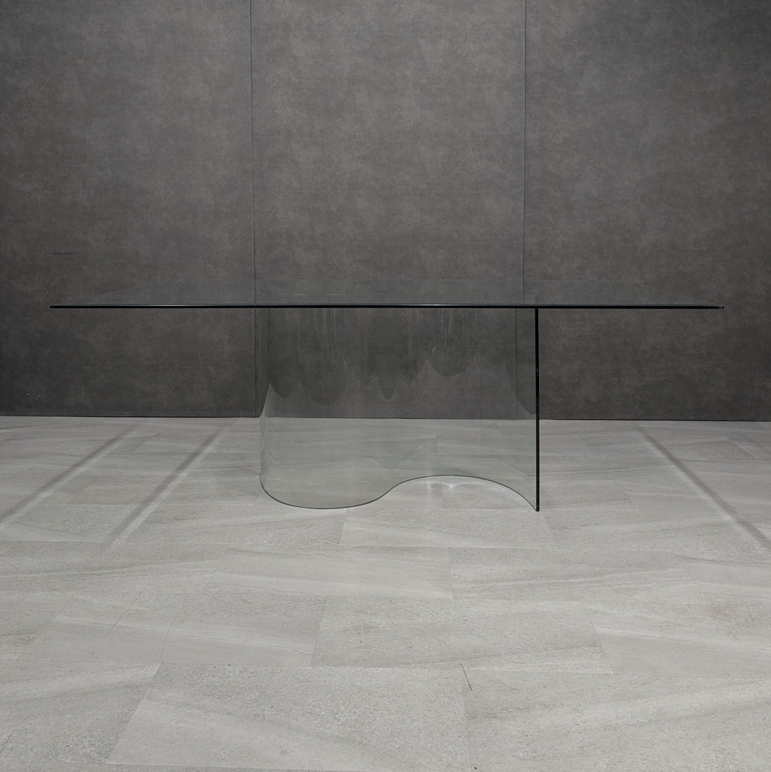 Clear glass S form pedestal dining table, front view